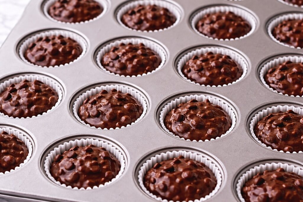 brownie bites batter in mini muffin pan before baking