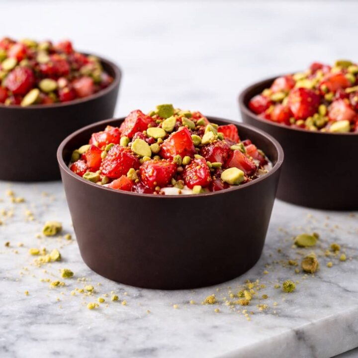 Dubai chocolate strawberry cups with dark chocolate shells and strawberry pistachio filling