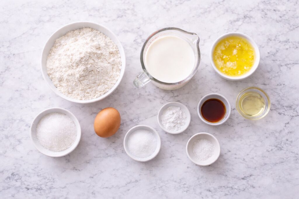 Ingredients for buttermilk pancakes including flour, egg, buttermilk and butter