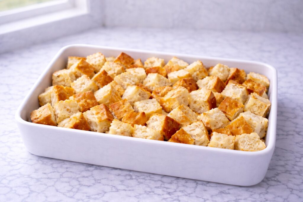 bread cubes arranged in a baking dish for french toast casserole