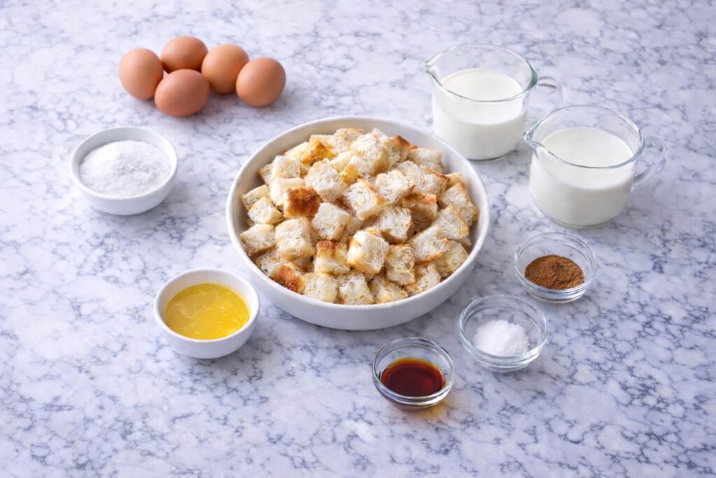 ingredients for french toast casserole including bread, eggs, milk, cinnamon, sugar, and vanilla