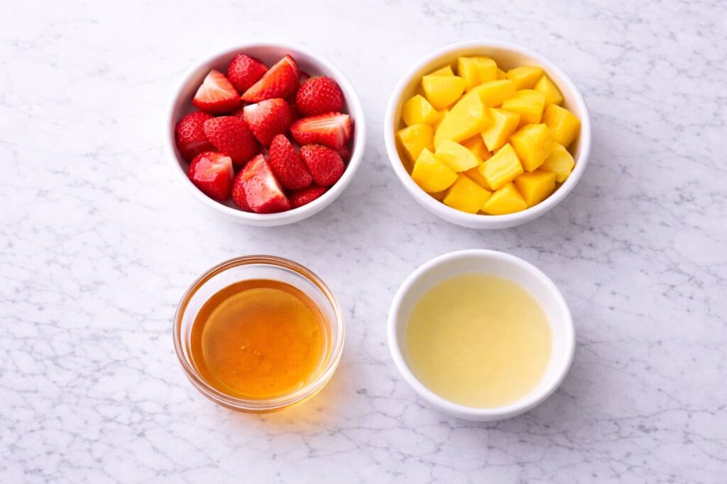 Fruit Roll Ups Ingredients (Simple Fruit Leather Recipe) ingredients for fruit roll ups including strawberries mango honey and lemon juice