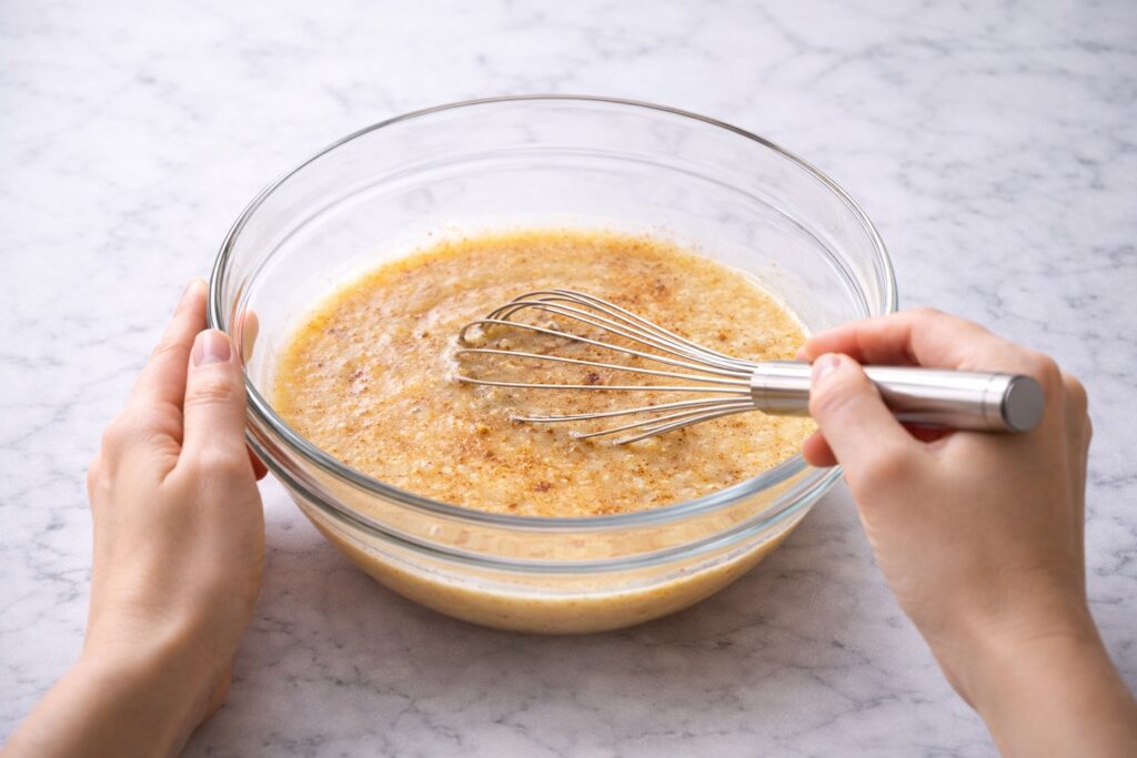 whisking eggs milk sugar vanilla and cinnamon for french toast custard