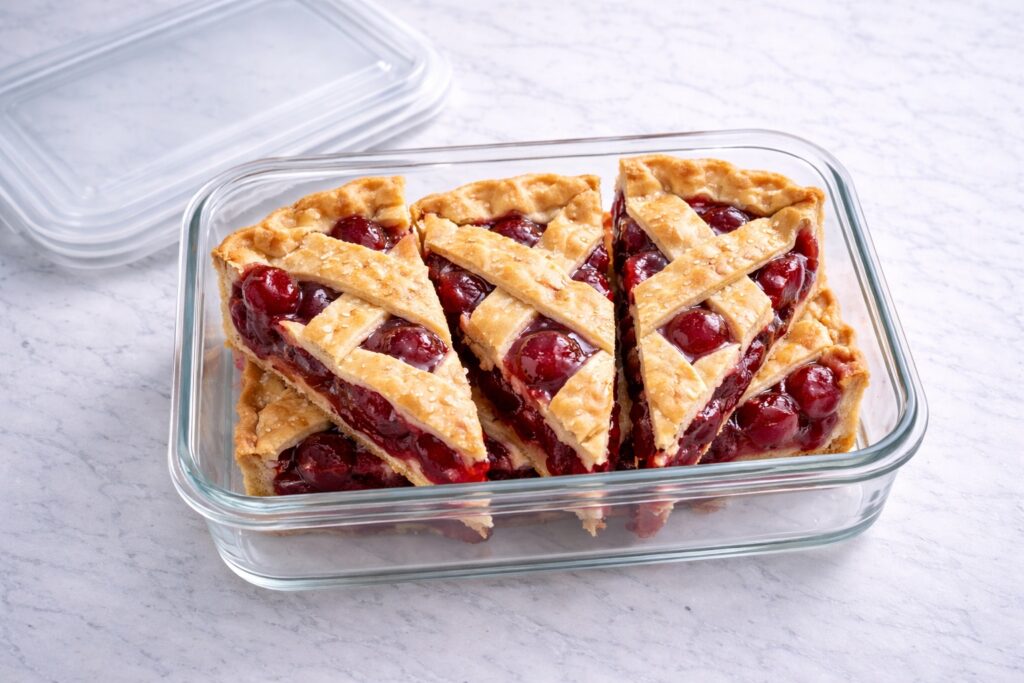 Cherry pie slices stored in glass container for refrigerator storage