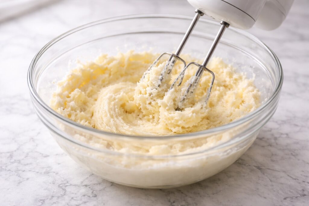 butter and sugar being mixed until light and fluffy for edible cookie dough