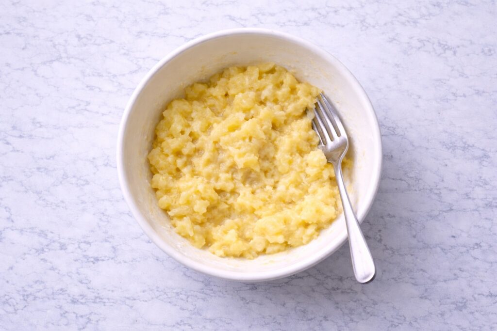 mashing ripe bananas for banana muffins