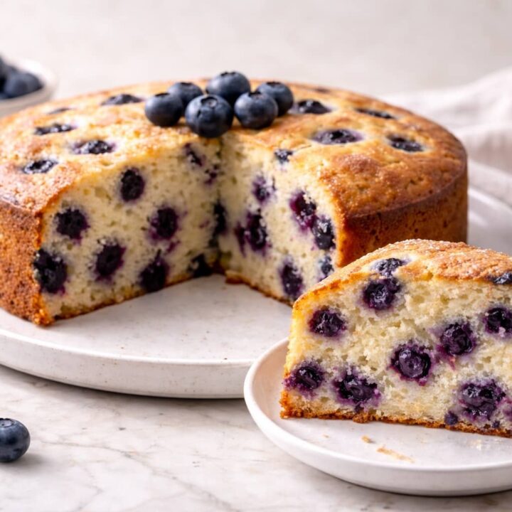 Homemade blueberry cake with a soft moist crumb and fresh blueberries baked in a round pan.