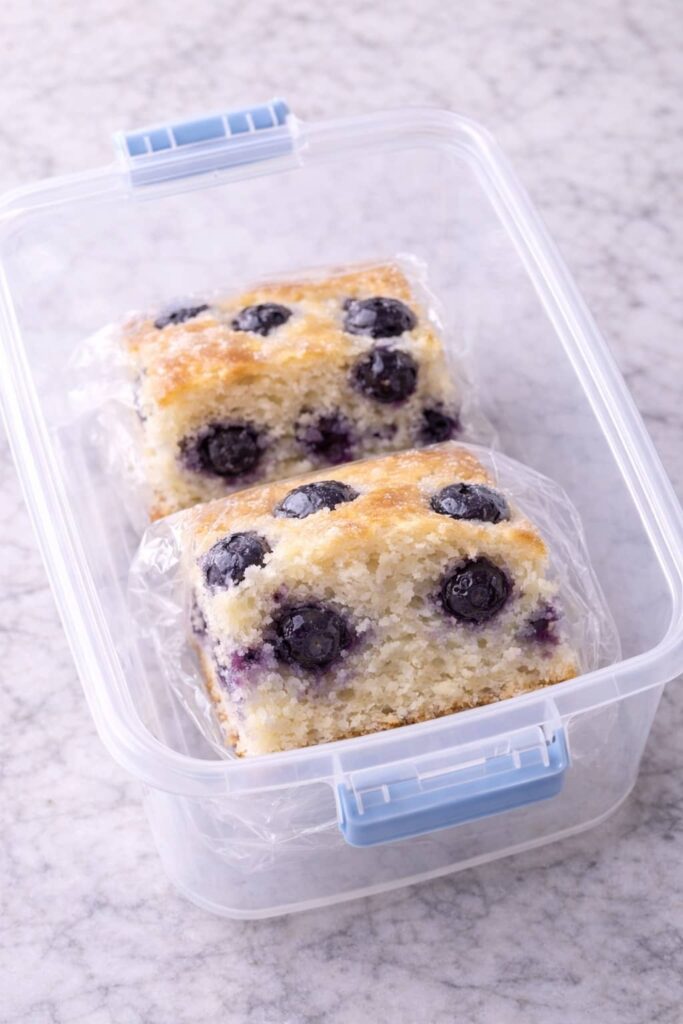 How to store blueberry cake slices in an airtight container to keep them fresh.