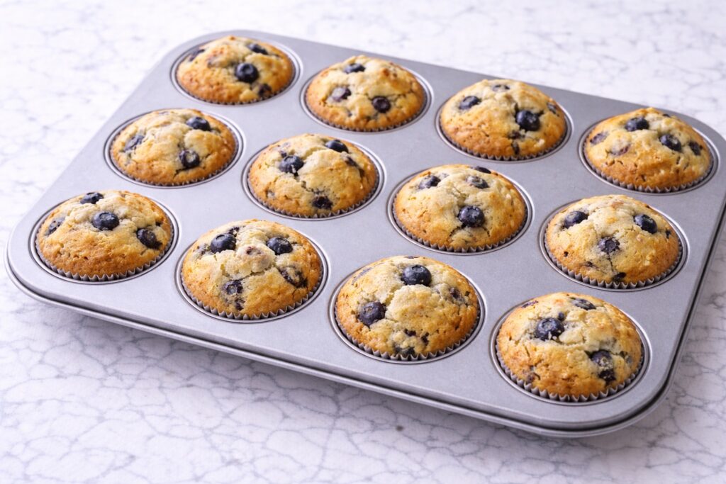 freshly baked blueberry muffins cooling after baking