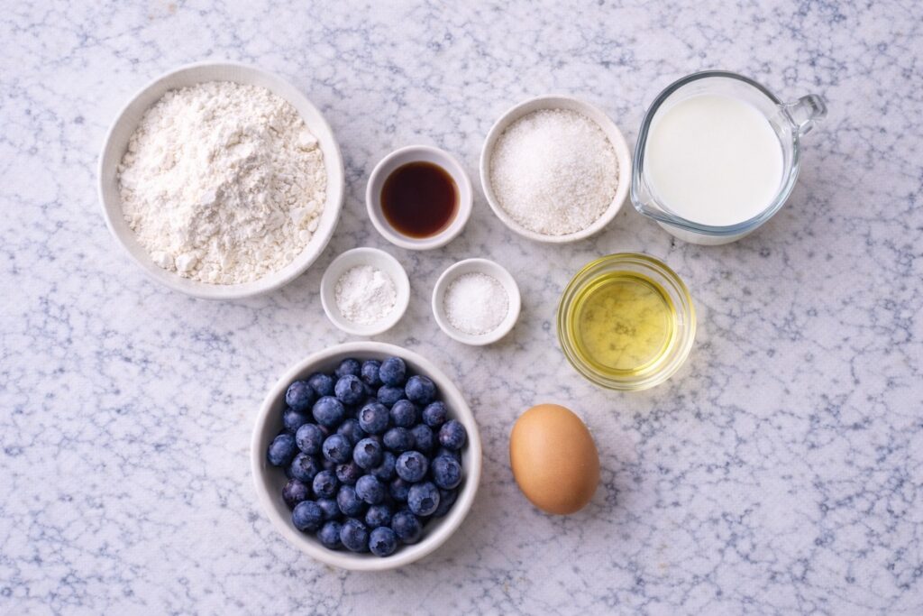 ingredients for blueberry muffins recipe flour sugar milk egg blueberries