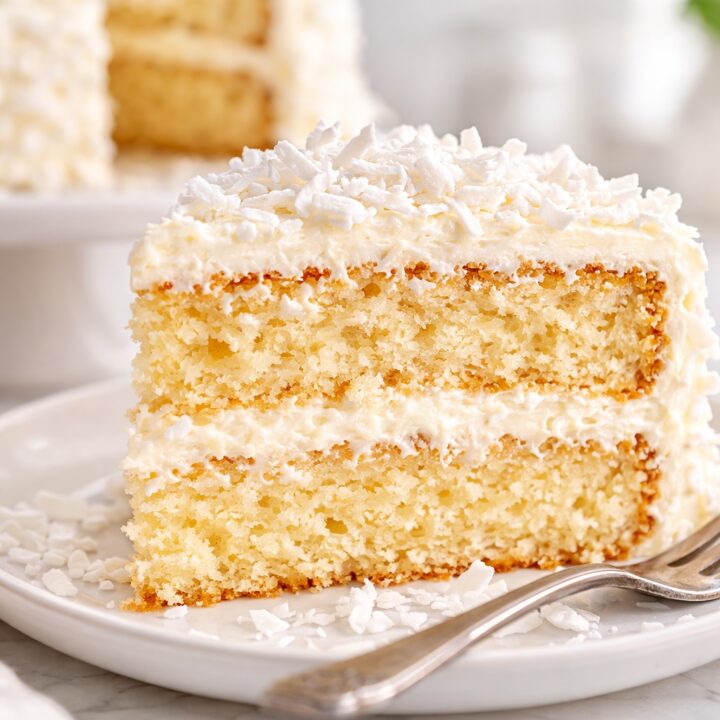 Coconut cake cross section showing fluffy sponge layers and coconut frosting.