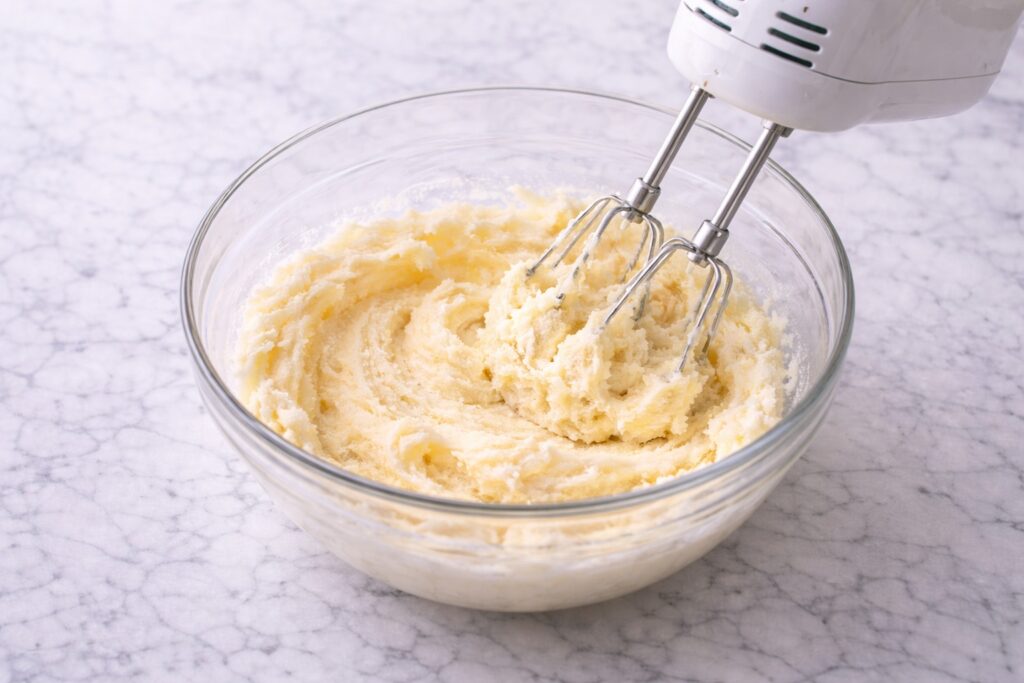 Creaming butter and sugar together for coconut cake batter.