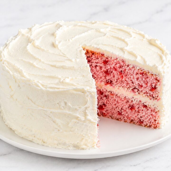homemade strawberry layer cake with moist pink layers and cream cheese frosting