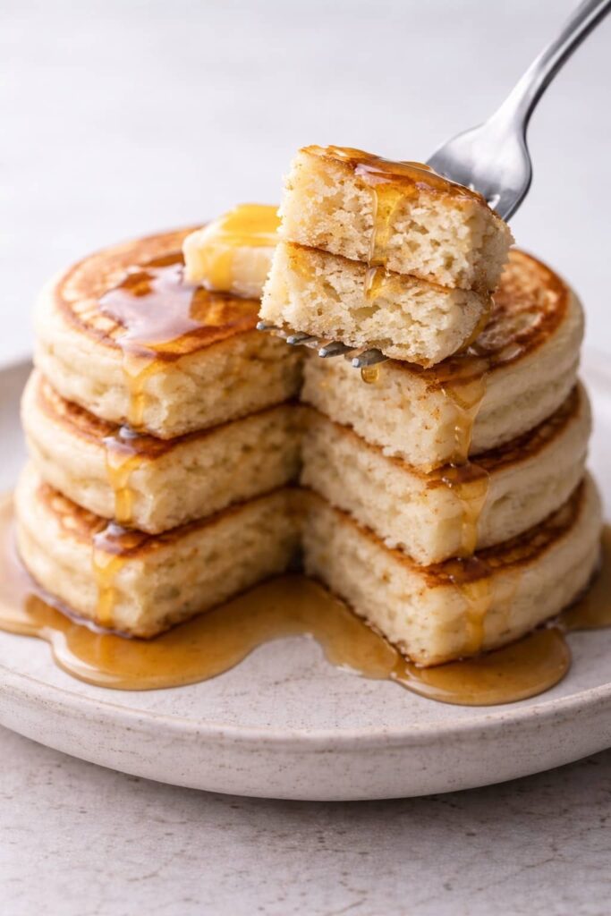 Close-up of fluffy sourdough discard pancakes showing soft interior texture