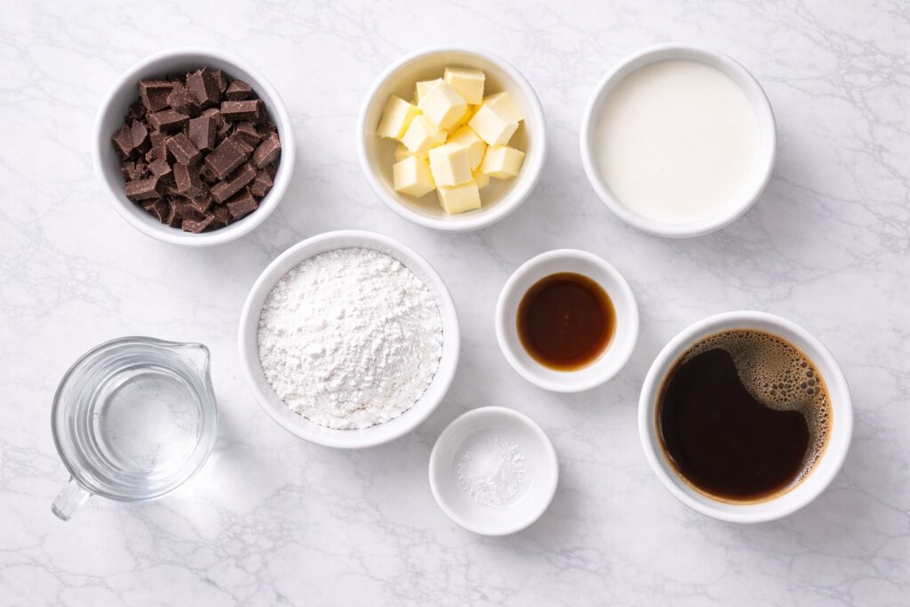 chocolate mousse ingredients arranged in bowls flat lay on marble surface