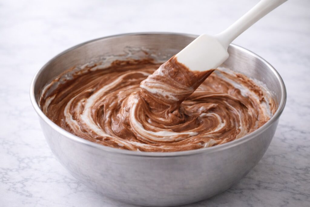 chocolate mousse base partially mixed with whipped cream showing marbled texture
