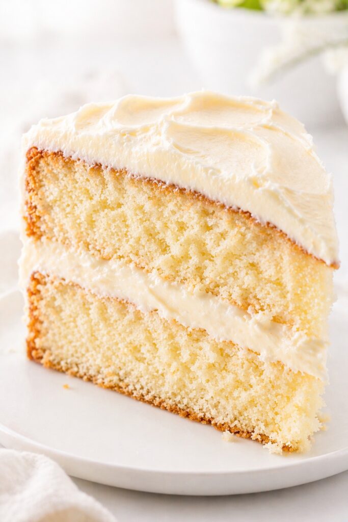 Vanilla Cake Texture Close Up Soft vanilla cake slice with creamy buttercream close-up