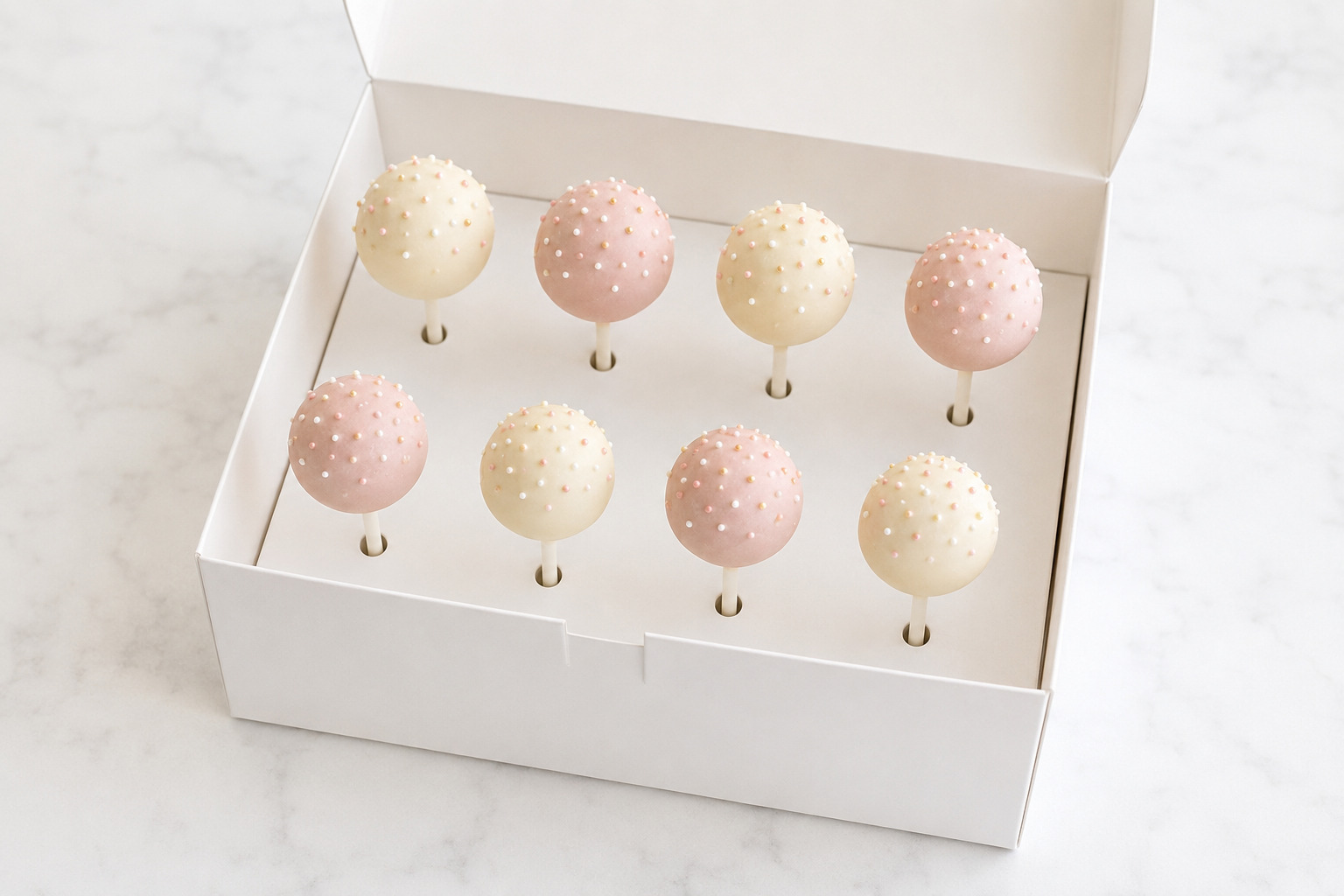 Cake pops packed upright in a fitted carrier for safe transport
