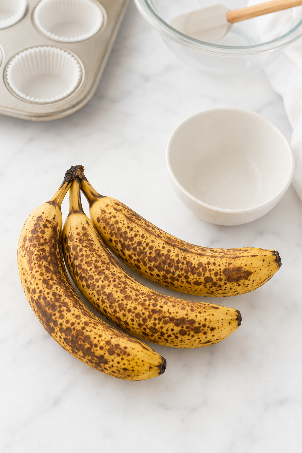 Very ripe brown-spotted bananas ready to be mashed for banana muffins.