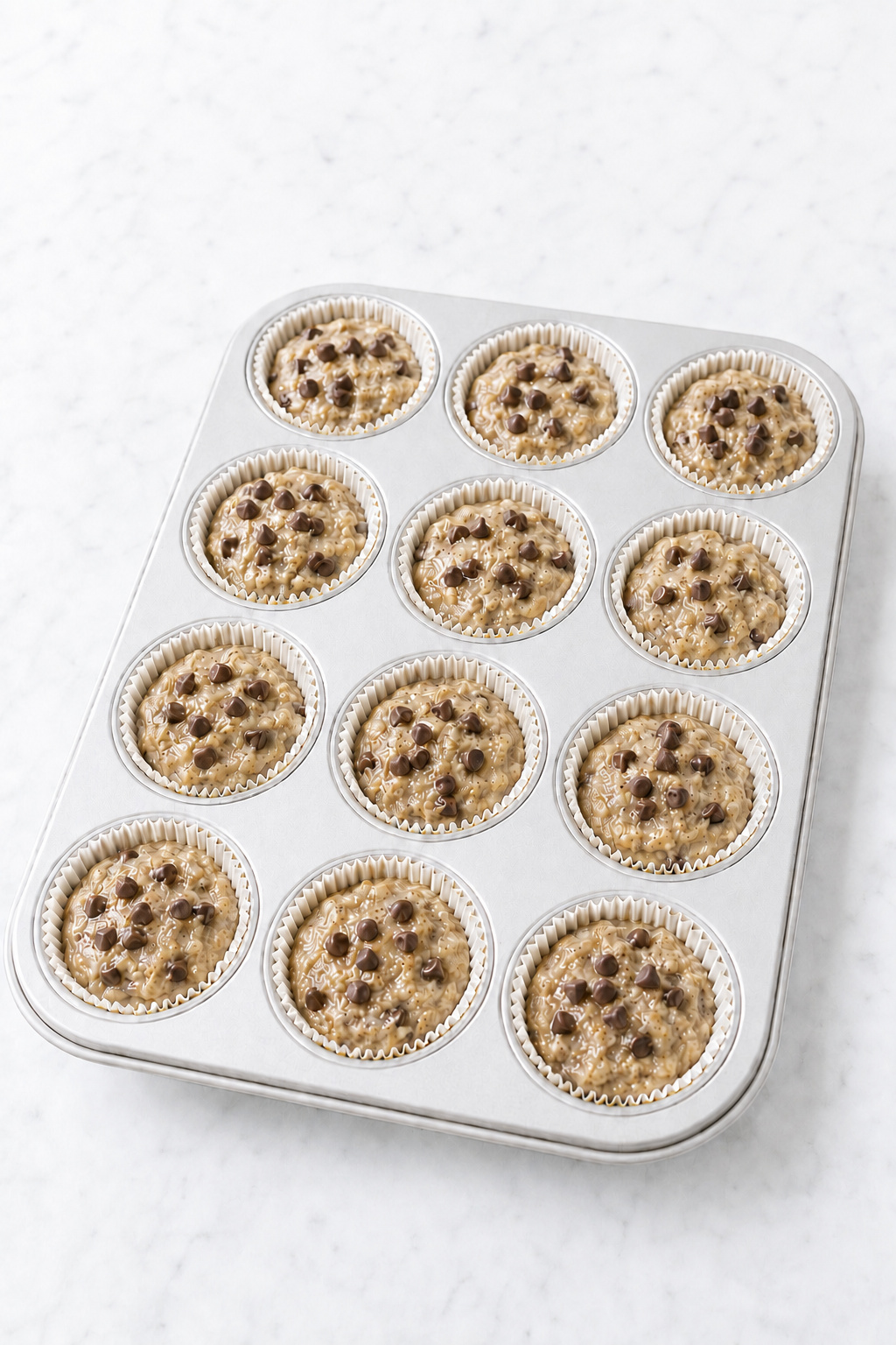 Reserved semisweet chocolate chips scattered over the muffin batter before baking.