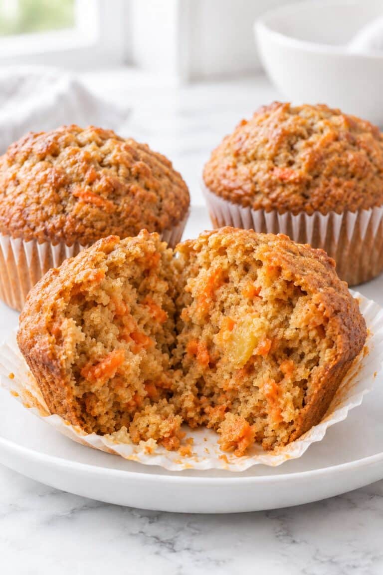 Carrot cake muffins with pineapple, including one muffin split open to show the moist crumb.