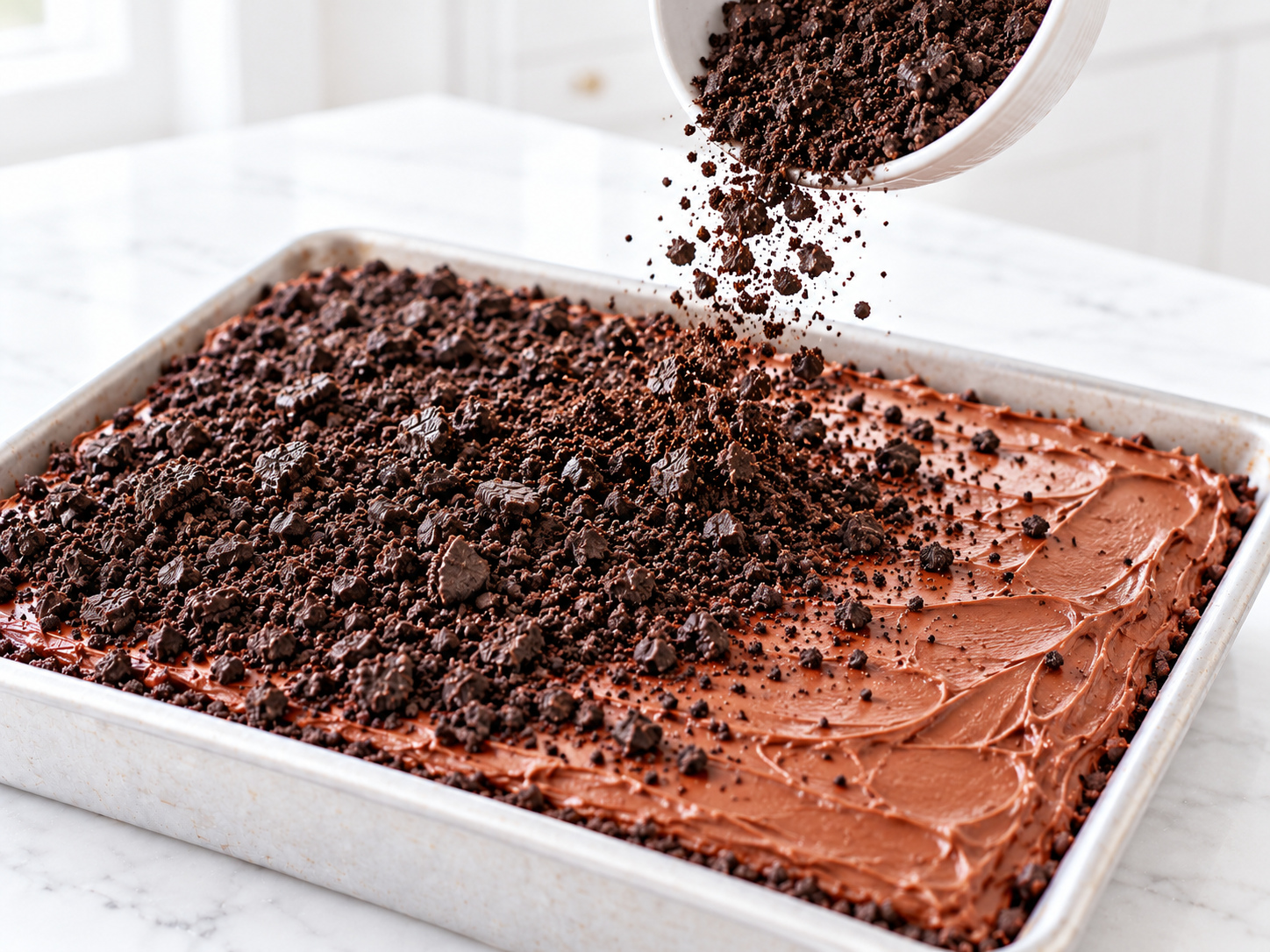 Crushed chocolate sandwich cookies scattered over frosting to create edible graveyard soil
